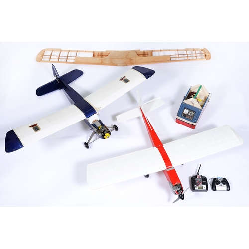 815 - Two painted balsa wood model aircraft, with Enya or other engine and related remote control installa... 