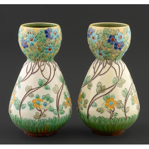 25 - Art pottery. A pair of Burmantofts garlic necked vases, c1900, moulded with a repeating design of st... 