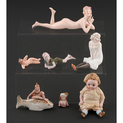 70 - Two Continental biscuit porcelain boudoir figures of reclining nude women and several other similar ... 