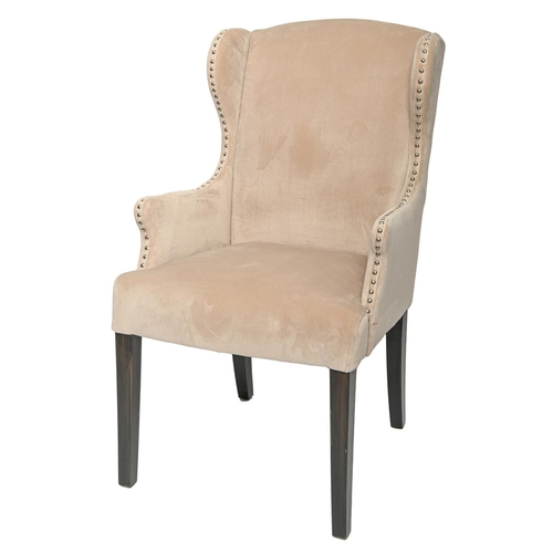 763 - A close nailed beige plush wingback armchair in George III style