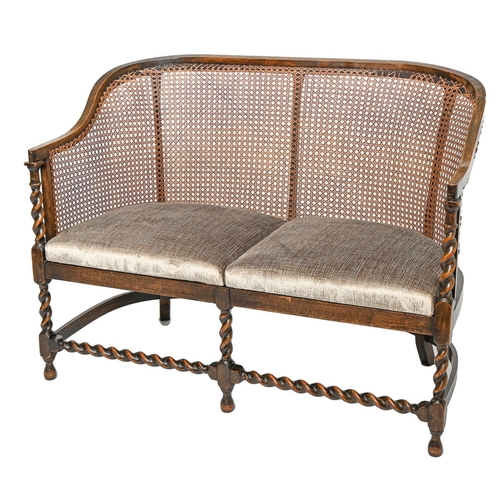 767 - A spiral turned oak twin seat settee with caned back, c1920, 113cm long