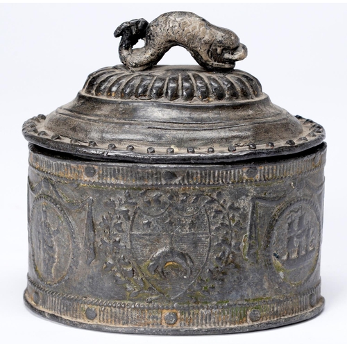 1028 - A George III oval lead tobacco jar and cover, cast with the arms of the Borough of Leeds flanked by ... 