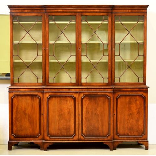 1359 - A mahogany breakfront bookcase, c1975, in George III style, the green painted interior with adjustab... 