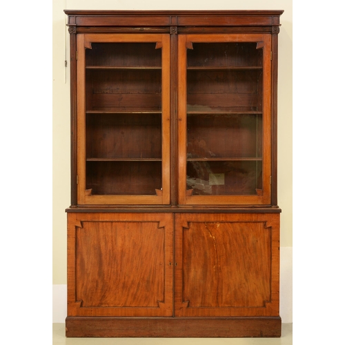 1358 - A Victorian mahogany bookcase, the upper part fitted with adjustable shelves enclosed by glazed door... 