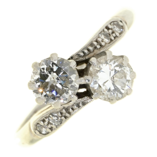 29 - A diamond crossover ring, with diamond set shoulders in platinum marked PLAT, 3.6g, size O... 