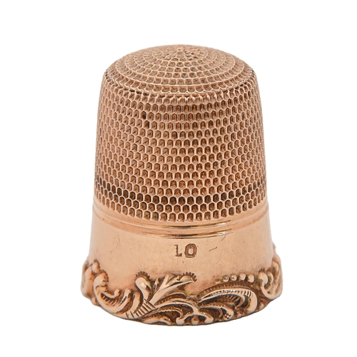 395 - A gold thimble, late 19th c, applied with C scrolls alternating with flowers, 21mm h, 4g... 