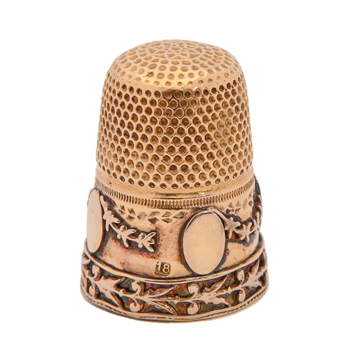 398 - A gold thimble, c1900, the skirt applied with festoons and medallions, 21mm h, marked 18, 5.6g... 