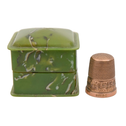 401 - A 9ct gold thimble, with floral border, part marked London 1921, in contemporary marbled green therm... 