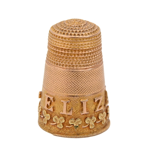 404 - A Victorian three colour gold thimble, applied with the name ELIZABETH in red gold and a band of clo... 