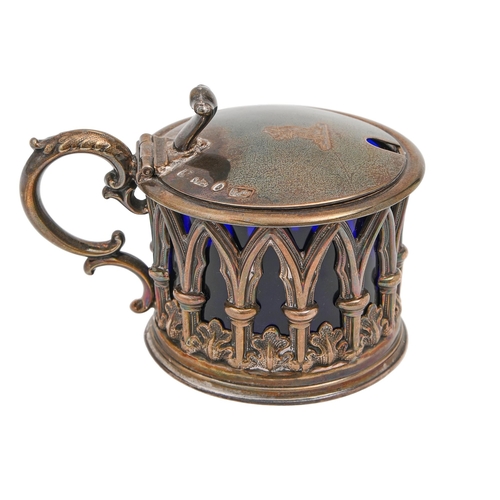 444 - A Victorian gothic silver mustard pot, the sides pierced with arches and water leaves, crested, blue... 