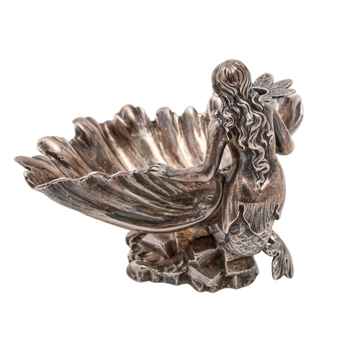 451 - A Victorian cast silver figural mermaid-and-shell taperstick,  with flower shaped nozzle, 85mm h, by... 