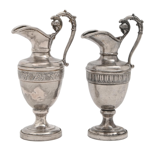 458 - A pair of Continental miniature silver ewers, 19th c, of shield shape, the handle terminating in the... 