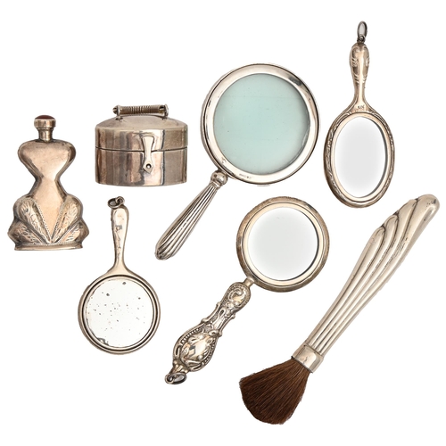 461 - Three miniature silver hand mirrors, a magnifying glass, scent bottle, silver handled brush and mini... 