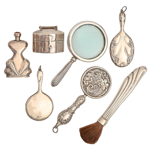 461 - Three miniature silver hand mirrors, a magnifying glass, scent bottle, silver handled brush and mini... 