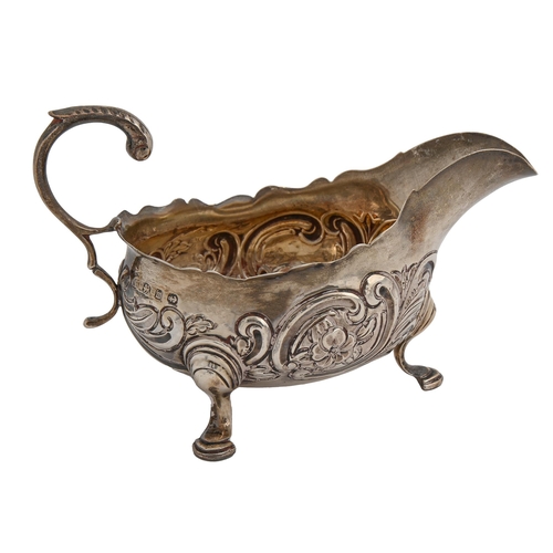 467 - A Victorian silver sauceboat, in mid 18th c English style, chased with flowers and C-scrolls, 12cm l... 