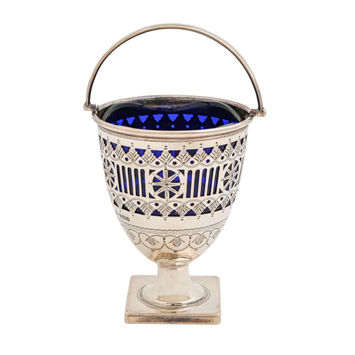 483 - An Edwardian pierced and engraved silver sugar basket, with swing handle, on square foot, blue glass... 