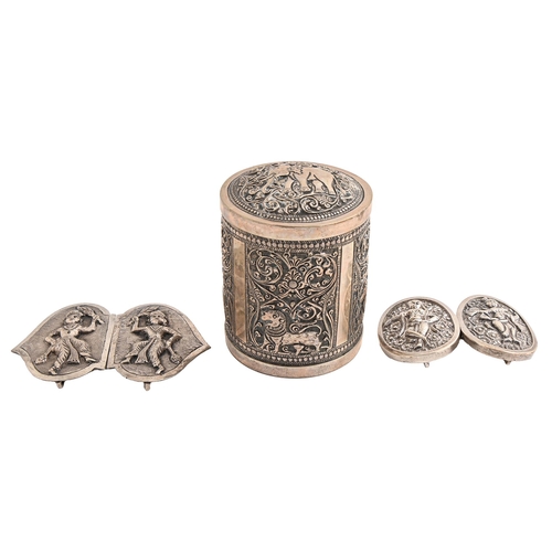 486 - Two South East Asian silver repousse waist clasps and a Burmese cylindrical silver repousse canister... 