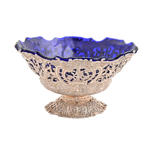 518 - A Dutch cast openwork silver fruit bowl, chased with figures and flowers, on pierced foot, blue glas... 