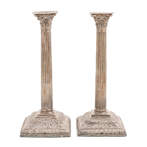 521 - A pair of George III silver candlesticks, with gadrooned nozzle and square base, Corinthian capital ... 