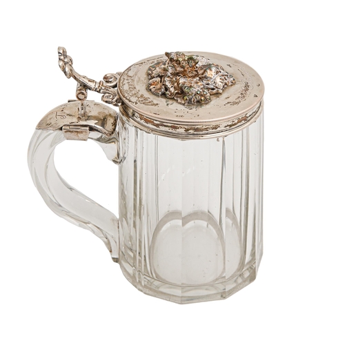 524 - A German silver mounted glass tankard, c1869, the lid applied with deer's head finial amidst fruitin... 