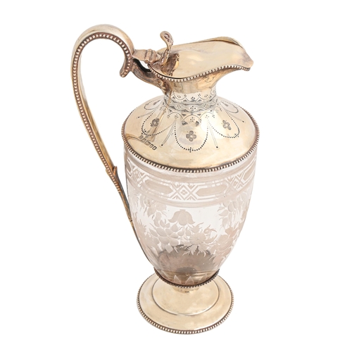 532 - A Victorian silver mounted glass claret jug, of shield shape, engraved with festoons within beaded r... 