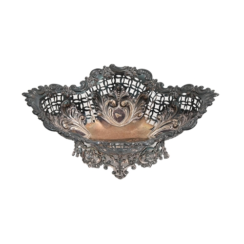 542 - A Victorian silver sweetmeat dish, stamped with leafy scrolls over open trellis, on cast openwork fo... 