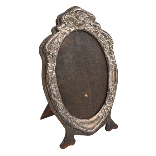 551 - An Edwardian Art Nouveau silver mirror or photograph frame, the die stamped mount with insects and f... 