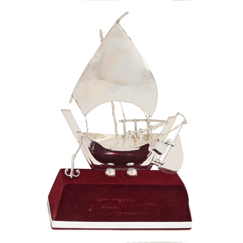 561 - A miniature foreign silver model of a sailing vessel, 20th c, mounted on velvet covered plinth, 19cm... 