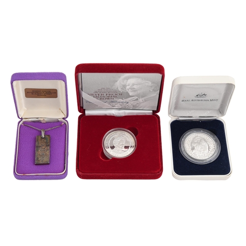 574 - Two United Kingdom proof silver commemorative crowns, each cased and a silver 1oz ingot pendant (3)... 