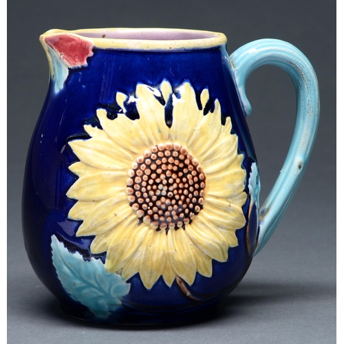 604A - A majolica sunflower jug, late 19th c, the interior in pink glaze 13.5cm h
