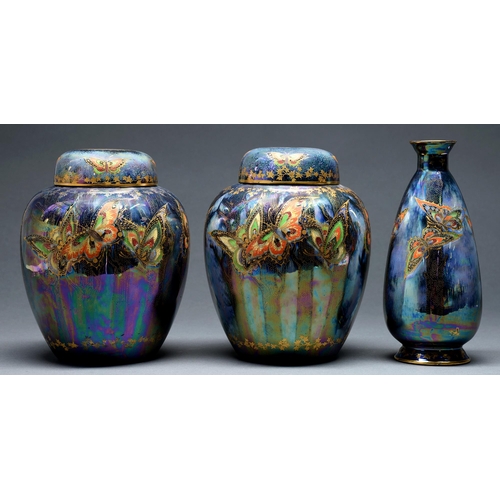 606 - A pair of S Fielding & Co Lustrine ginger jars and covers and a vase, C1920-30, decorated with b... 