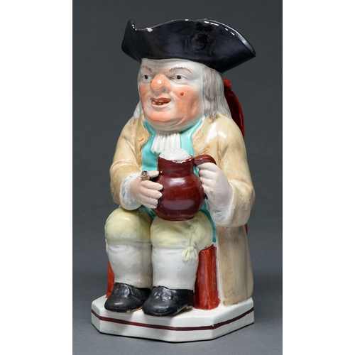 637 - A Staffordshire Toby jug, c1820,  the seated toper holding a foaming jug of ale, wearing a ligh... 