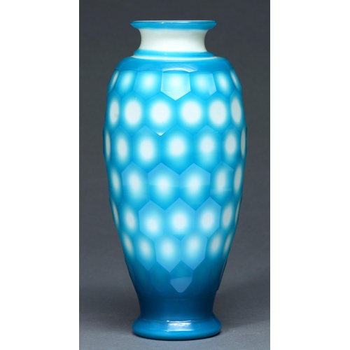645 - A Chinese glass vase, 20th c, the creamy opal glass cased in blue and cut with hexagons, 28.5cm h... 