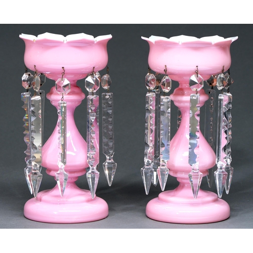 647 - A pair of Victorian pink cased white glass lustres, with baluster stem and hung with prismatic cut b... 