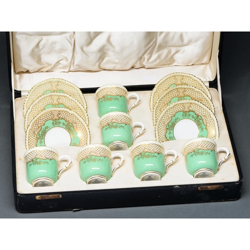 655 - A set of six Royal Worcester apple green ground coffee cups and saucers, 1936, with gilt trellis bor... 