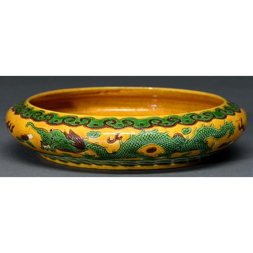 679 - A Chinese green, aubergine and yellow glazed dragon bowl, 20th c,  with incised decoration, 22cm dia... 