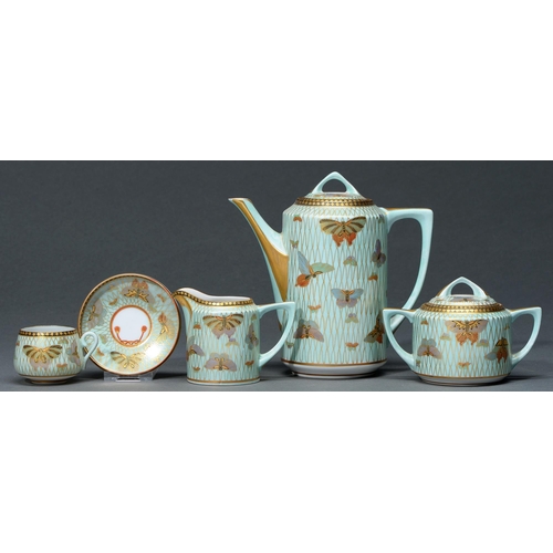 708 - A Japanese porcelain coffee set, c1920,  decorated with butterflies and gilt net over a pale green g... 