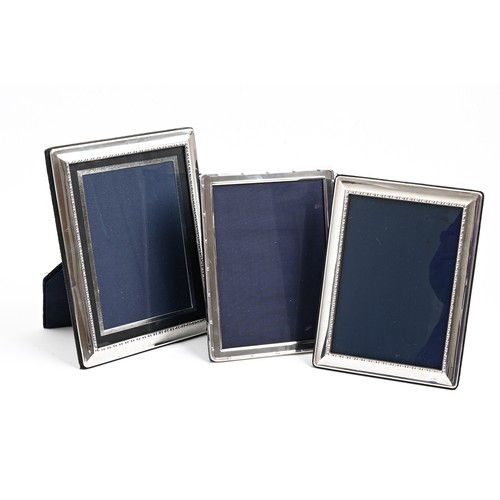 543 - Three Elizabeth II silver photograph frames, 23.5 x 18.5cm and smaller, by Carrs of Sheffield Ltd, 1... 