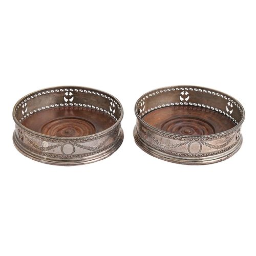 117 - A pair of George III neo classical pierced and bright cut silver wine coasters, with beaded rim and ... 