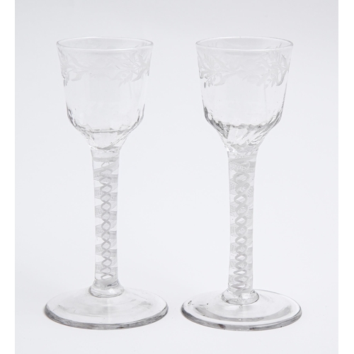 184 - Two English wine glasses, c1770, the ogee bowl engraved with trailing flowers, on multiple series op... 