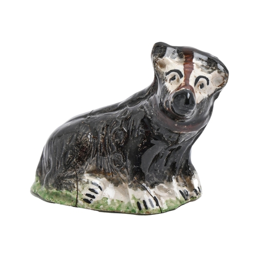 193 - Bear baiting. A Staffordshire creamware model of a bridled bear, c1820, with black, brown and green ... 