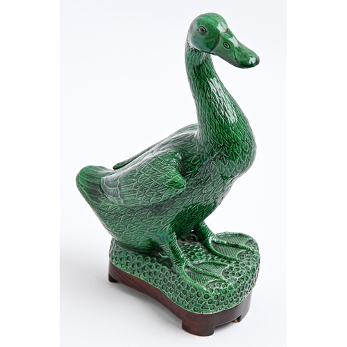 198 - A Chinese green glazed biscuit model of a goose, 20th c, 24cm h, wood standThe collection of C. W. B... 