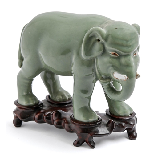 200 - A Chinese celadon model of an elephant,  20th c, 18cm h, wood stand (2)The collection of C. W. Brigg... 