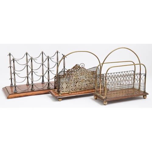 335 - Two Edwardian brass canterburys, on walnut or oak base, 32cm h and a later metal bottle rack on wood... 