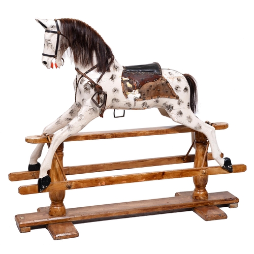 397 - An English painted wood rocking horse, with brass nailed leather and horsehair mane and tail, saddle... 