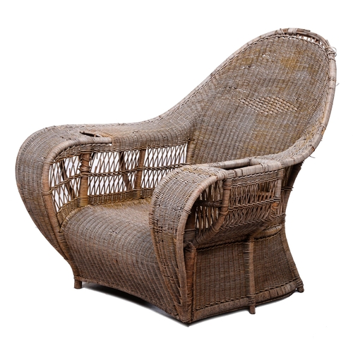 400 - Dryad. An Arts & Crafts wicker armchair, early 20th c, the broad arms with basket or cup holder,... 