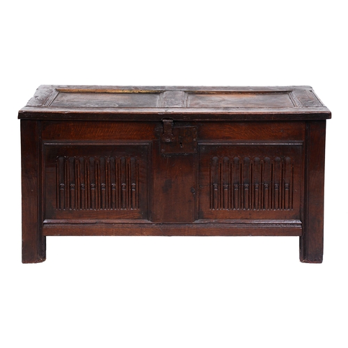 411 - A Charles II oak chest, the nulled front with two nulled panels and iron lockplate, on channelled st... 