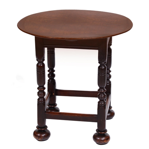 425 - An oak table, 19th c, the round top on square frame and turned legs with stretchers and bun feet, 60... 