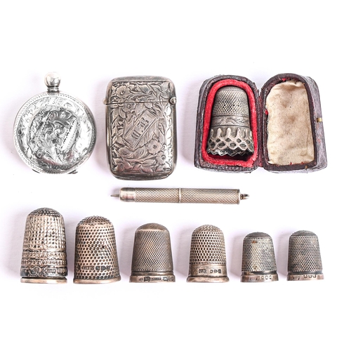 74 - Eight silver thimbles, late 19th and early 20th c, a Victorian silver vesta case, Birmingham 1892, a... 