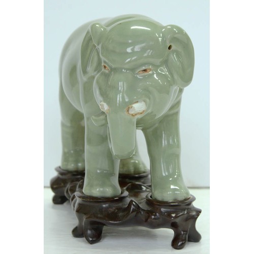 200 - A Chinese celadon model of an elephant,  20th c, 18cm h, wood stand (2)The collection of C. W. Brigg... 